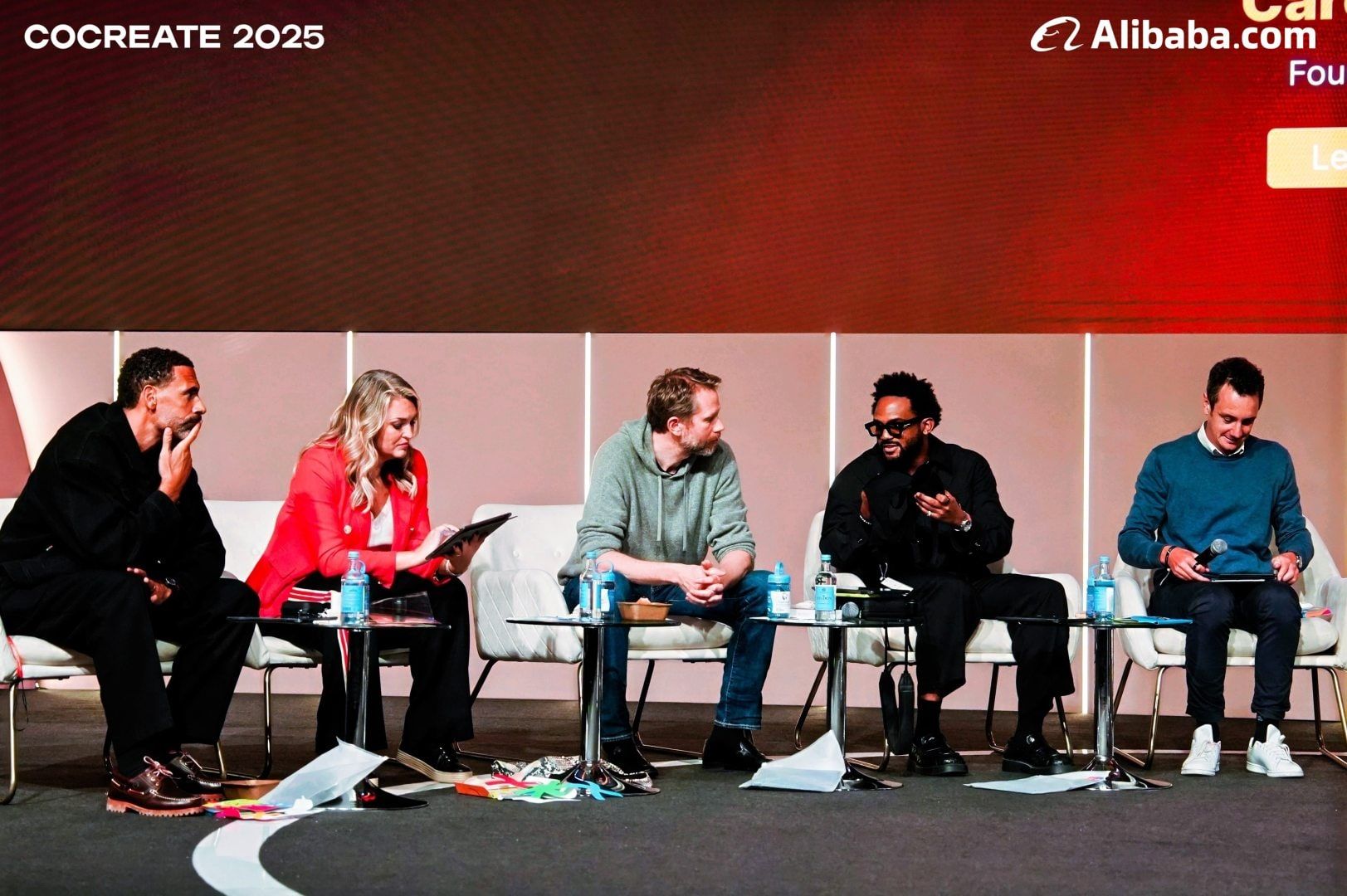 The Alibaba CoCreate 2025 judging panel seated on stage at the O2, Rio Ferdinand at the far left