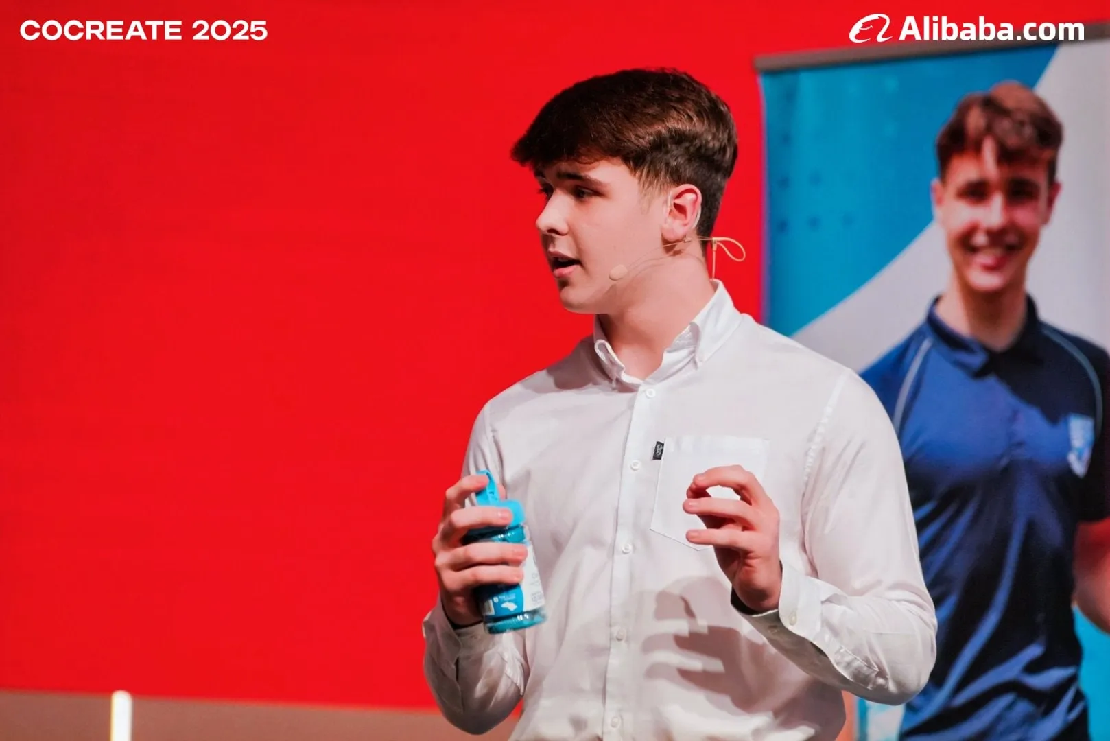 Harrison Nott mid-pitch on stage at Alibaba CoCreate